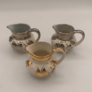 Individual cream pitchers, silver overlay or gold.
